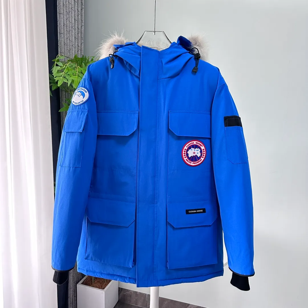 P700 CANADA GOOSE｜Canada Goose Expedition Parka｜Classic upgrade New 08 style Color: graphite gray, off-white, black, pink, navy blue, sky blue, Size: XS, S, M, L, XL, XXL, Product introduction Loose fit, multi-pocket design Larger size for free movement. 6 exterior pockets: 4 reversible front pockets, zippered side entry. There is a practical pocket on the left sleeve and a top pocket on the right sleeve. There is a drawstring on the inside of the waist and a logo patch on the back. The waist is designed with an inside drawstring, which can be adjusted to provide excellent warmth. Woven grab straps at upper back with “Expedition” logo patch • Hood with removable zipper trim, interchangeable hood trim for personalization and added protection (this jacket is not available with the classic hood trim) • Chin protection element has a tricot inner fabric for softness and comfort • Woven grab straps at upper back with “Expedition” logo patch • Internal drawstring at the waist, adjustable to provide excellent warmth •Snap-in rib knit cuffs for added comfort and optimal heat locking in •Stylish hanging inner straps allow the jacket to be carried over the shoulder, hands-free •Stowaway nylon stretch snow skirt for added protection •Two-way zipper covered fly with Velcro® snaps that unzips from the bottom for increased range of motion and breathability. A windproof fly is designed under the zipper for an extra layer of protection. • 6 exterior pockets: 4 two-way pockets on the front with top flap and Velcro® snaps, and zippered side entry. Utility pockets on left sleeve and right sleeve with top flap and velcro® snaps Internal pockets: 1 zipped pocket, 2 mesh drop-in pockets Embroidered Canada Goose logo